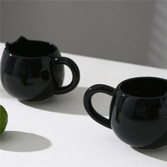 Adorable hand - painted cat - shaped ceramic mug, perfect for coffee or tea.